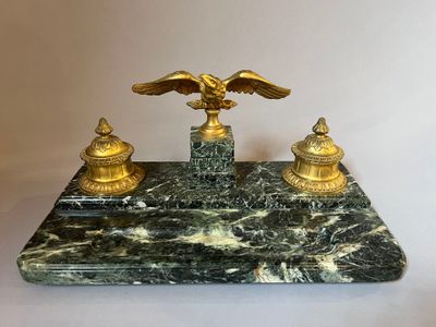 an image of a marble desk with a golden eagle on top of it