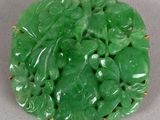 a close up of a green broochee with leaves on it