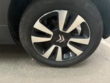 a close up of a car ' s wheel on a parking lot