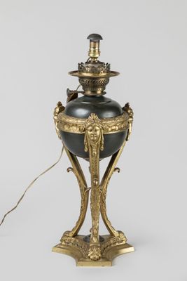 an image of a black and gold lamp on a white background