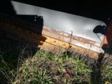 a close up view of a machine that is laying in the grass