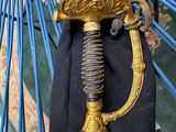 a gold and black sword on a blue chair