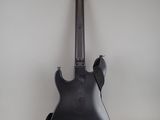 an electric guitar sitting on top of a white table
