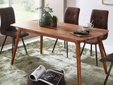 a wooden table with chairs and a magazine on it