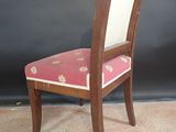 a wooden chair with a pink upholstered seat