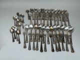 a lot of silver spoons and spoon spoons on a table