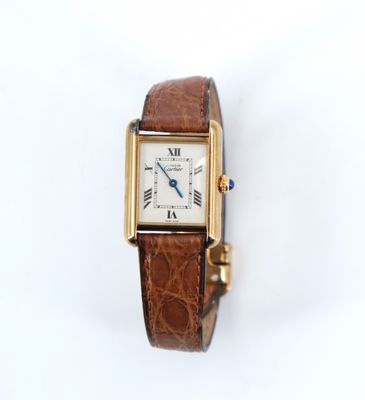 a close up of a wrist watch with a brown leather band