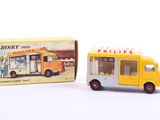 a small yellow toy bus next to a box of pills