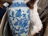 a cat that is sitting on top of a vase