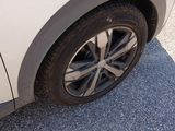 a close up of a car ' s tire on a gravel road