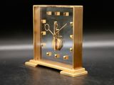 a clock that is sitting on a table in the dark