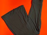 a pair of black pants sitting on top of an orange surface