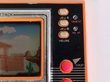 an orange and black game console with a picture on the screen