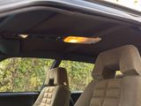 two seats in the back of a car with a yellow light