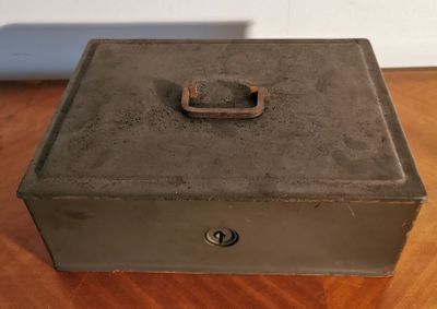 a metal box with a latch on it on a table