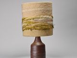 a lamp that is sitting on a table with a lamp shade on it