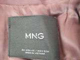 a close up of a label on a pink jacket