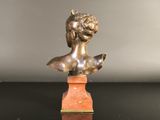 an antique bronze bust of a woman on a marble base