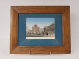 framed picture of a view of a street with a clock tower in the background