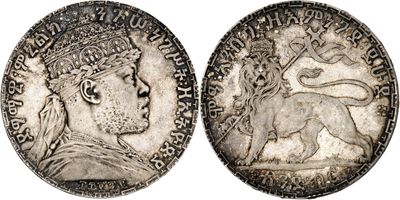 a silver coin with an image of a woman and a lion on it