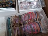 many pairs of glasses in a box on the table