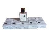 a bottle of perfume sitting on top of a stack of boxes