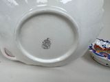 a white bowl with a blue and red design on it