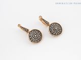 a pair of black and white diamond earrings on a white background