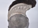 an old helmet with fur on top of it sitting on a stand