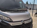 a silver van that is parked in a parking lot