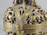 an image of a metal object with a design of animals on it