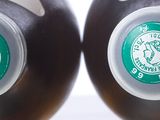 two black jugs with a green starbucks logo on them
