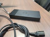 a laptop and a charger sitting on a wooden table