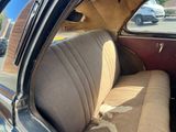 a dirty seat in the back of a car
