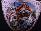 a vase with a painting on it sitting on a table