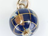 a blue and gold globe pendant on a white background
