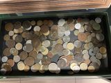 a lot of coins in a green box on the floor