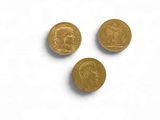 three gold coins with a portrait of a man and a woman on them