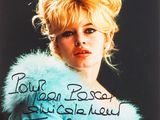 an old photo of a woman in a fur coat with writing on it