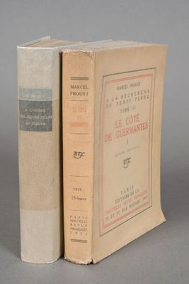 an old book sitting on top of a table next to another book