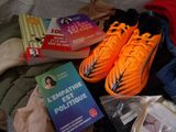 a pair of orange shoes and a book on a bed