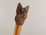 a wooden stick with a cat head on top of it