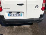 a white van parked in a parking lot next to a building