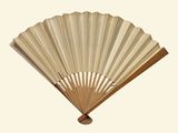 a wooden fan that is sitting on a white surface