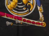 a picture of a black and gold scarf with a gold lion on it