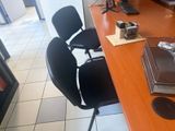 a desk with a chair and a laptop on it