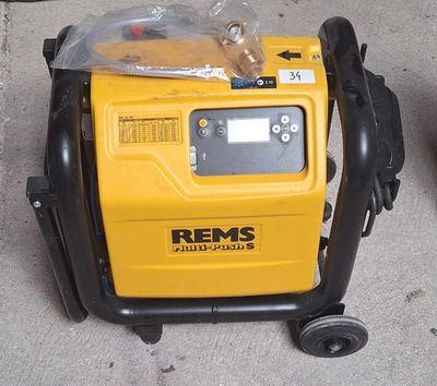 a yellow and black portable air compressor on the ground