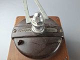 a close up of a metal object on a wooden surface