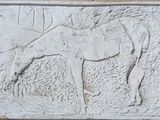 un relief représentant un cheval sur le mur d'un bâtiment
