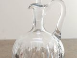 a clear glass decanter on a wooden table